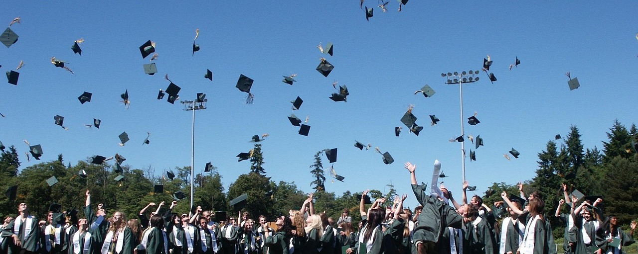 Students throwing their graduation caps into the sky